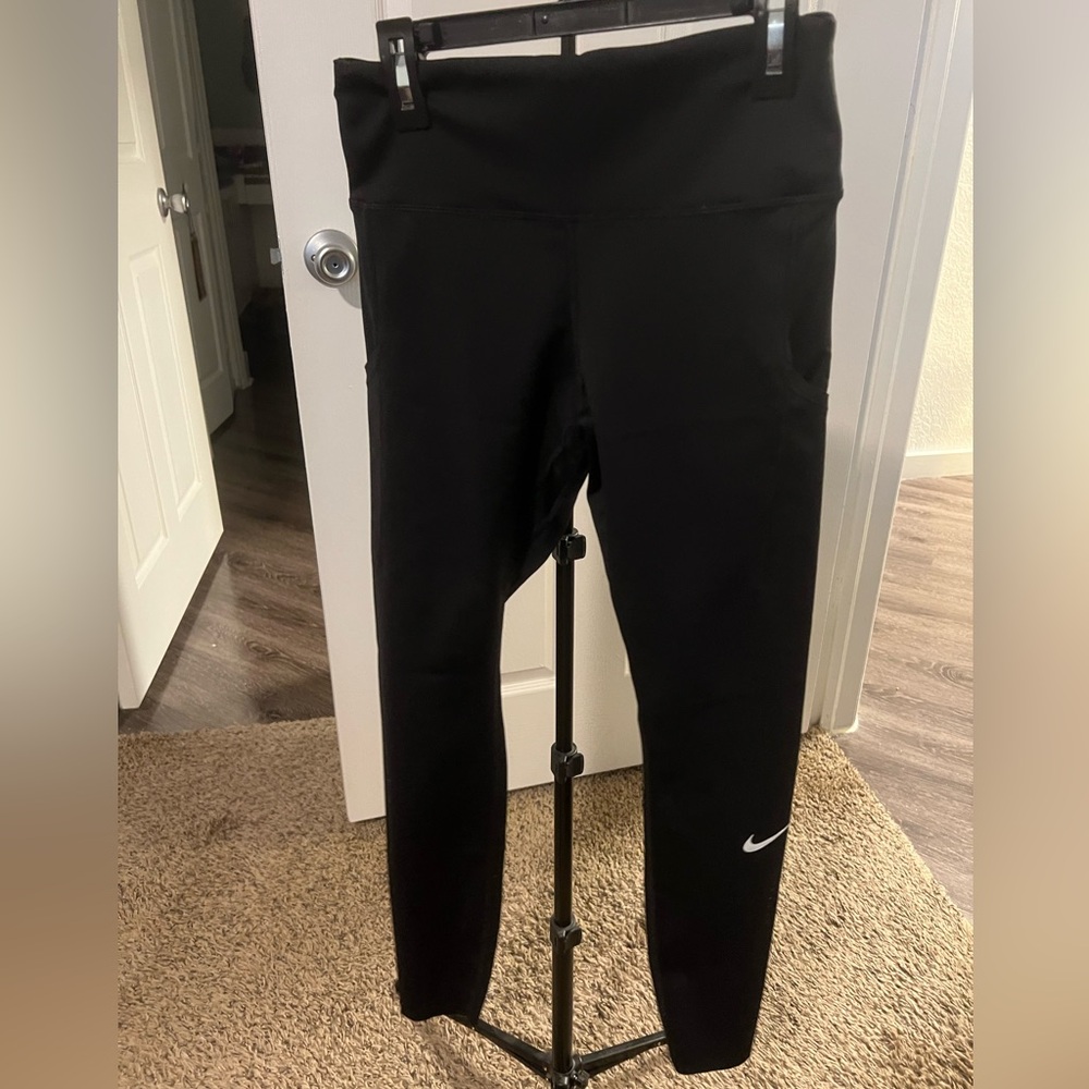 Nike leggings, black, has pockets, raw hem details.